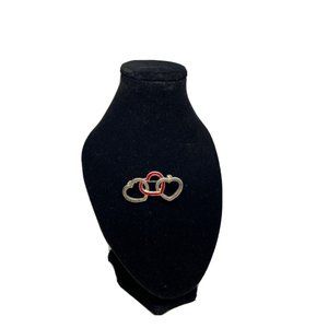 cute little brooch with 3 hearts and one red heart in the middle